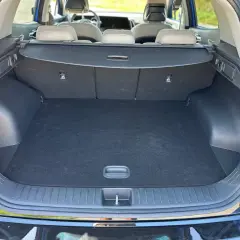 Pusty bagażnik Kia Sportage, gotowy na wakacyjne wyjazdy. Wygodny dostęp i spora przestrzeń.