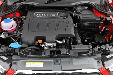 Silnik 1.6 TDI Audi z widocznym zbiorniczkiem płynu chłodniczego i osłoną silnika z logo TDI.