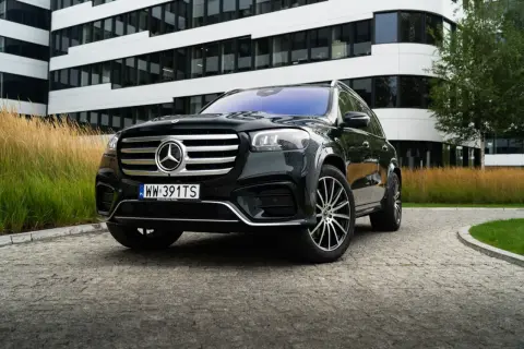 Elegancki, czarny Mercedes GLS na tle nowoczesnego budynku. Sprawdź, jaka jest jego mercedes gls cena.