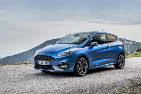 Niebieski Ford Fiesta ST na górskiej drodze, gotowy na każdą przygodę.