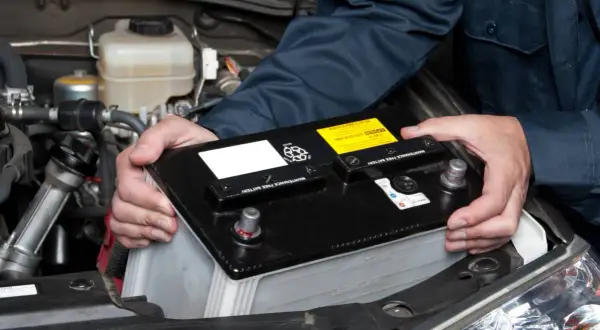 Wymiana akumulatora w dieslu 1.9 TDI 110KM. Mechanik montuje nowy akumulator.
