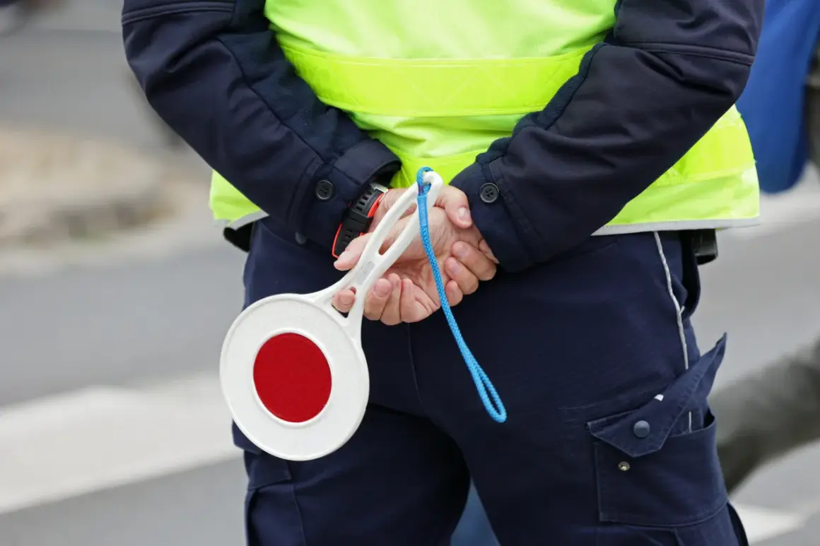 Policjant z tarczą stop. Uważaj na drogach, bo punkty karne 2025 mogą Cię zaskoczyć.